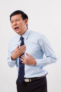 sick man suffering from acid reflux, gerd, heartburn, indigestion